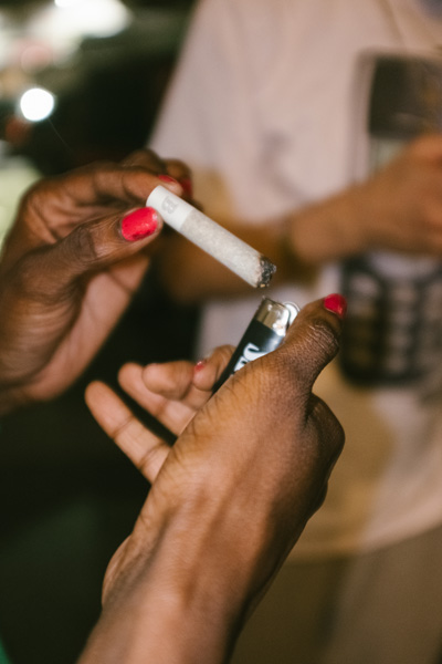 Someone lighting a Bundles preroll