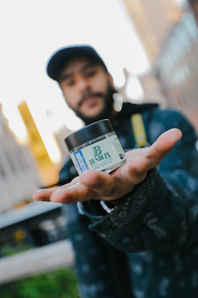 A person holding a cannabis jar