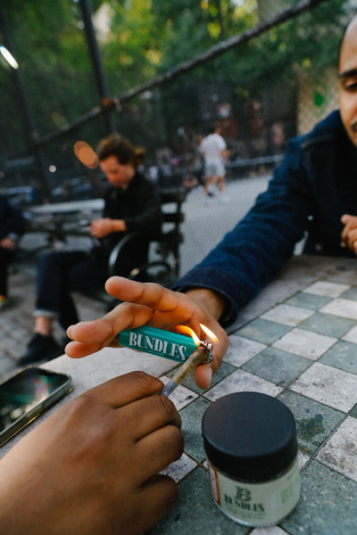 A person lighting a joint
