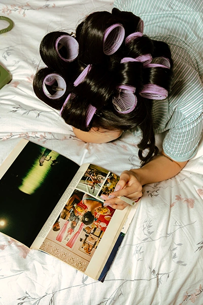 A person reading a magazine while smoking cannabis